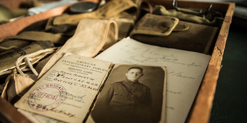 Old photos and letters are draped in a wooden drawer