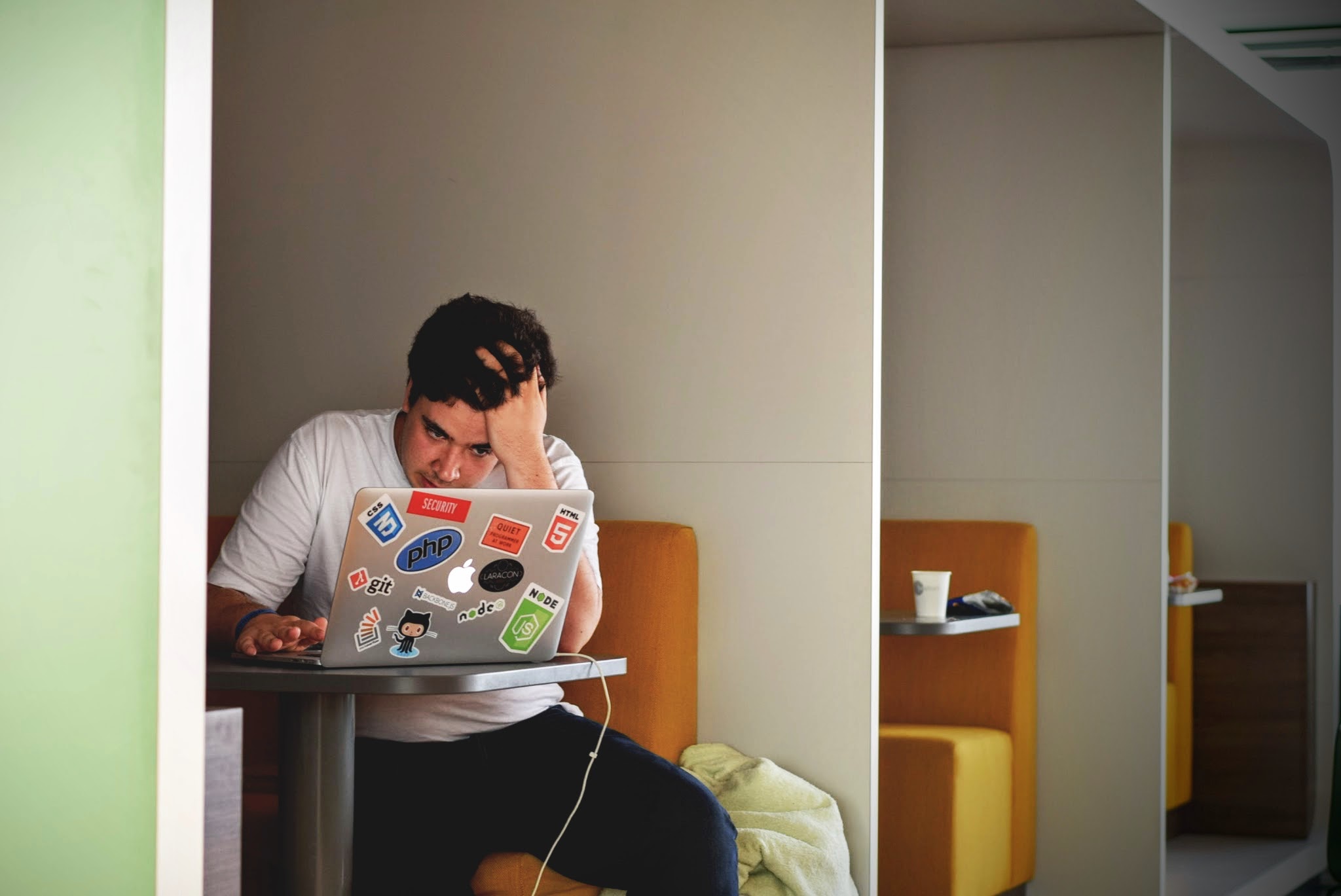 Image of a man who is frustrated and staring at his laptop.