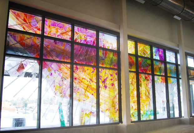 stained glass window of various colors of public art in central rec center in aurora