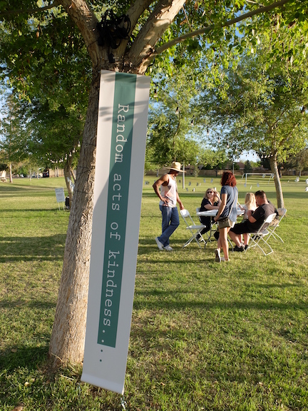 Picture in the park with text for random acts of kindness.