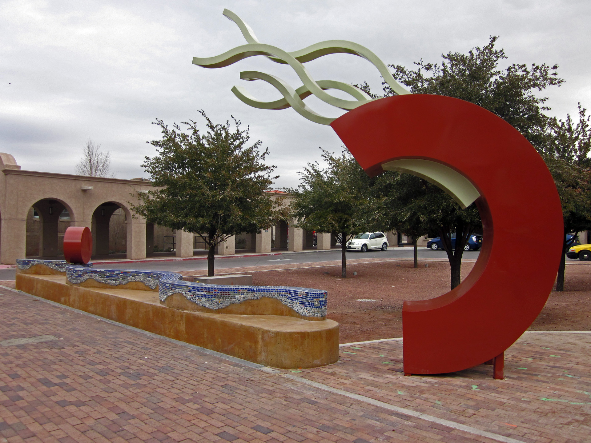 A Stop on the Rio Grande by John Davis - a red half circle with flame-like coming from the top toward the building