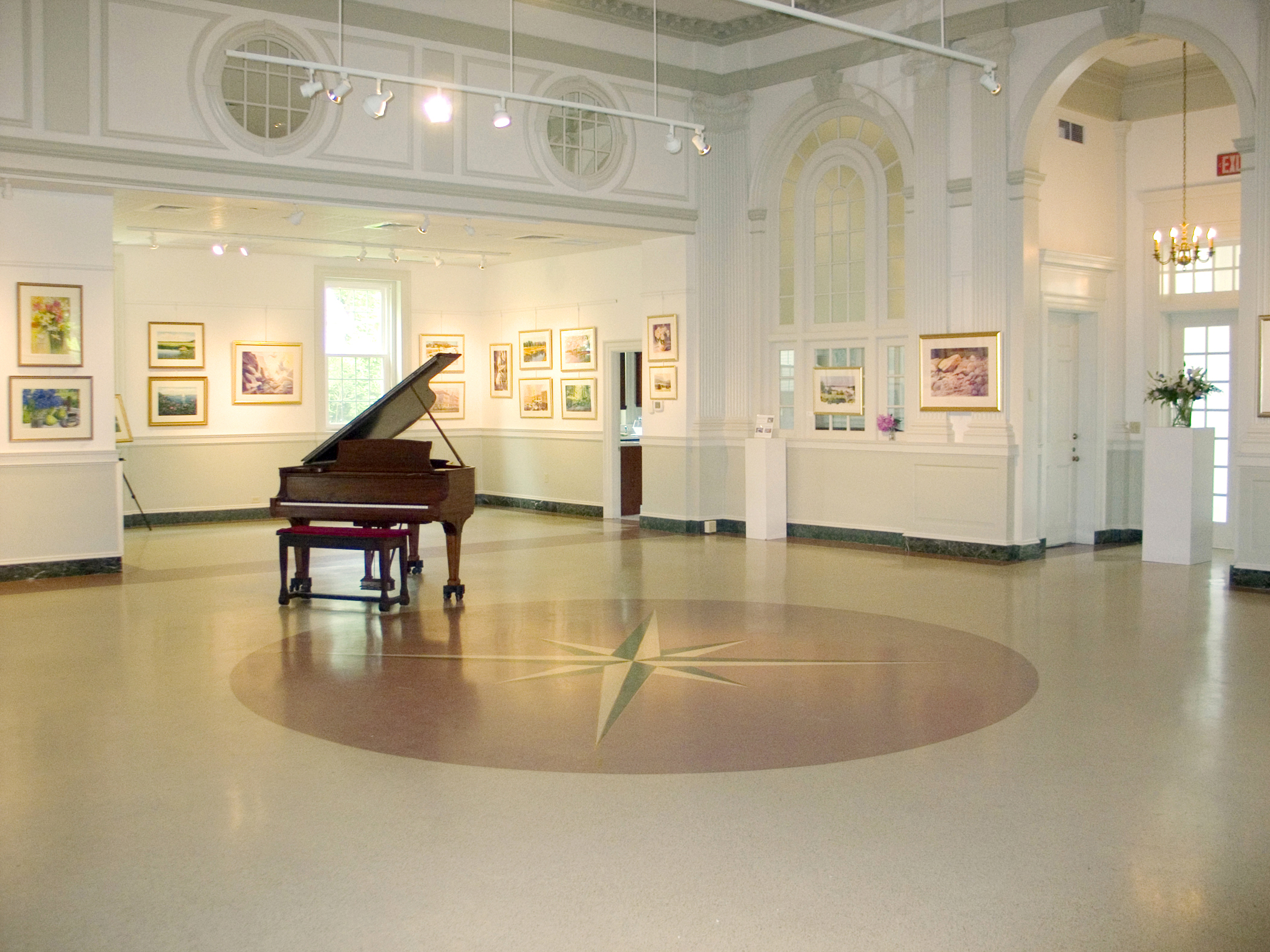 Interior of the cultural center of cape code with a big open space and a piano in the center.