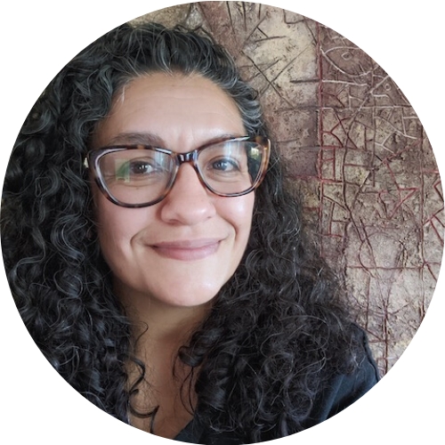 headshot of Raquel Vasquez standing in front of a brown and white multi-colored piece of art