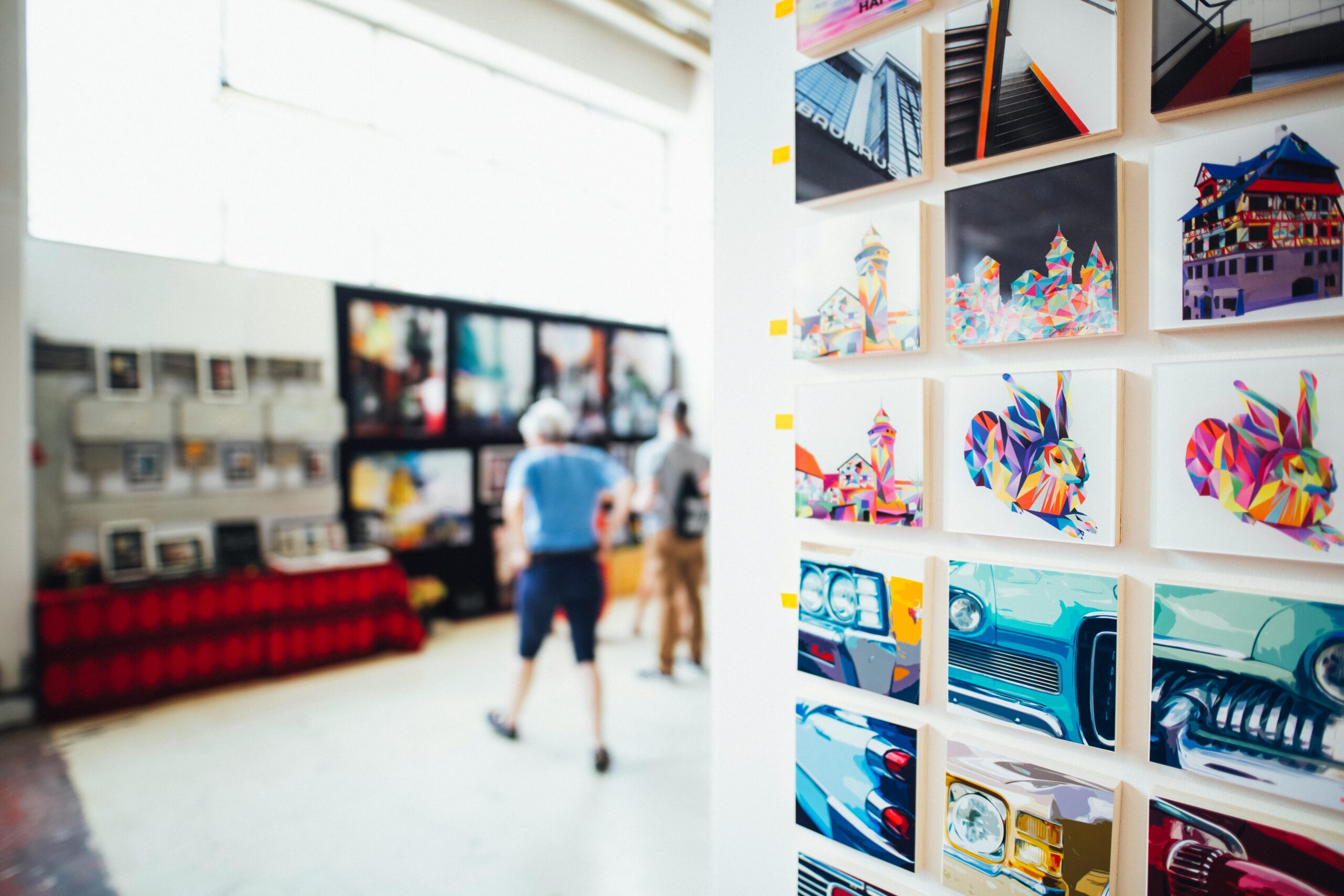 Image of several small art pieces hanging on a wall in an art gallery