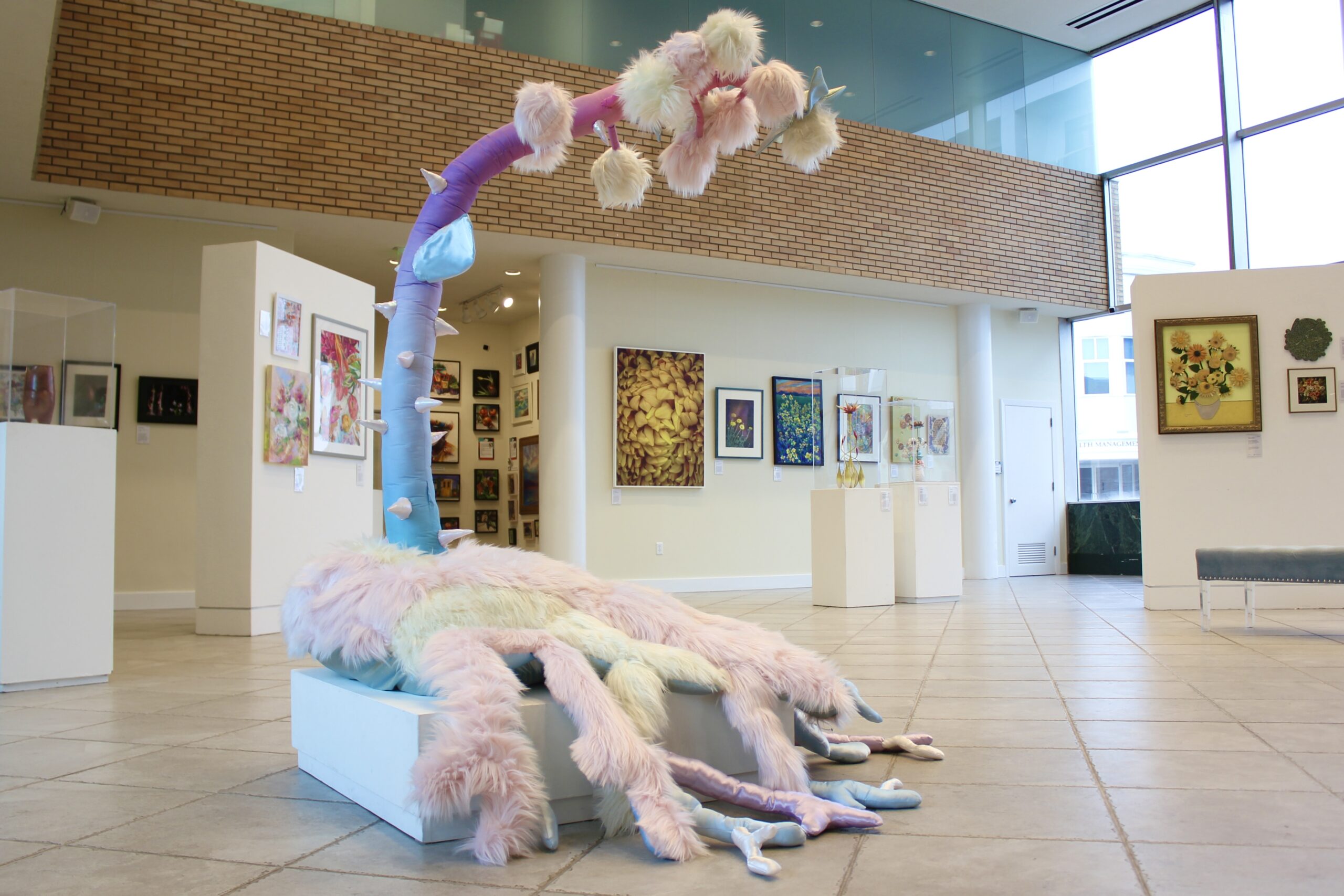 Large, multi-media sculpture in the center of the room exhibiting d'Art Center's Flourish exhibit.